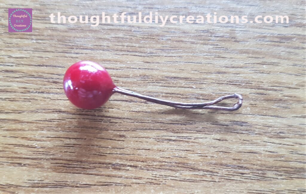 I removed a berry from the bunch and folded the stem in half.