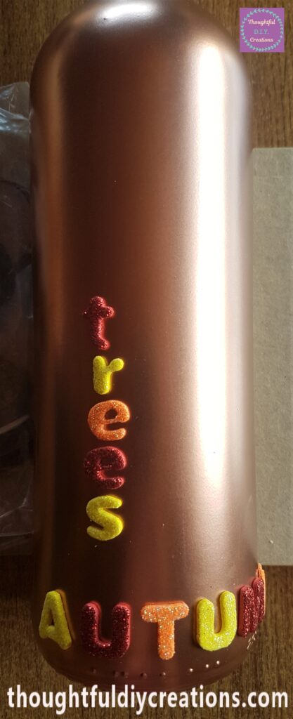 I removed the backing of each letter and attached them down the Autumn Bottle.