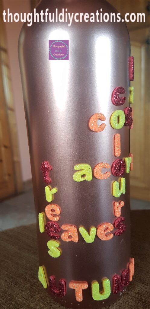 The Bottle standing up with the Autumn words attached.