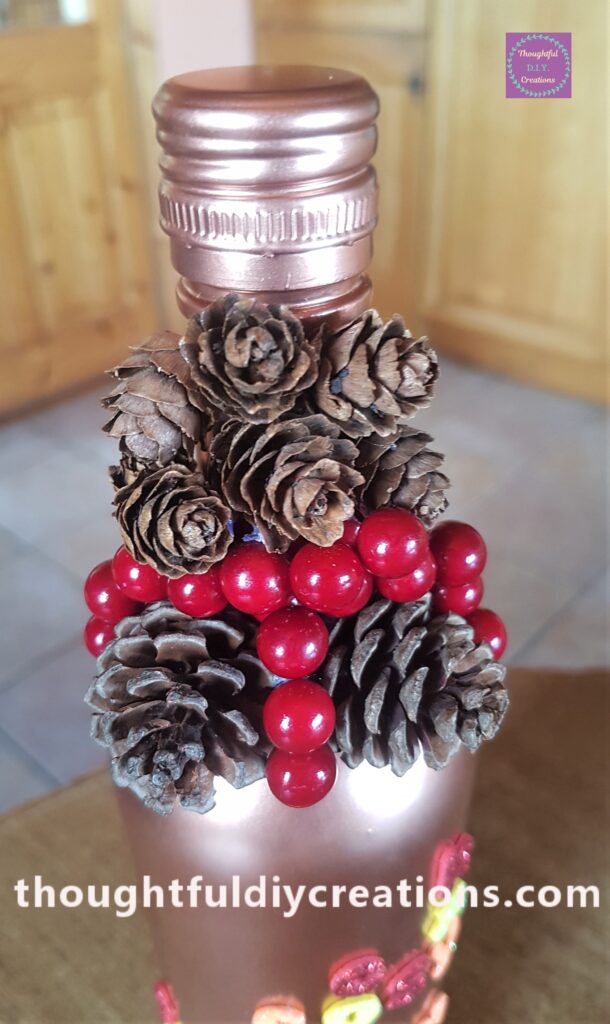I hot glued 6 mini pine cones to the top of the Autumn Bottle.