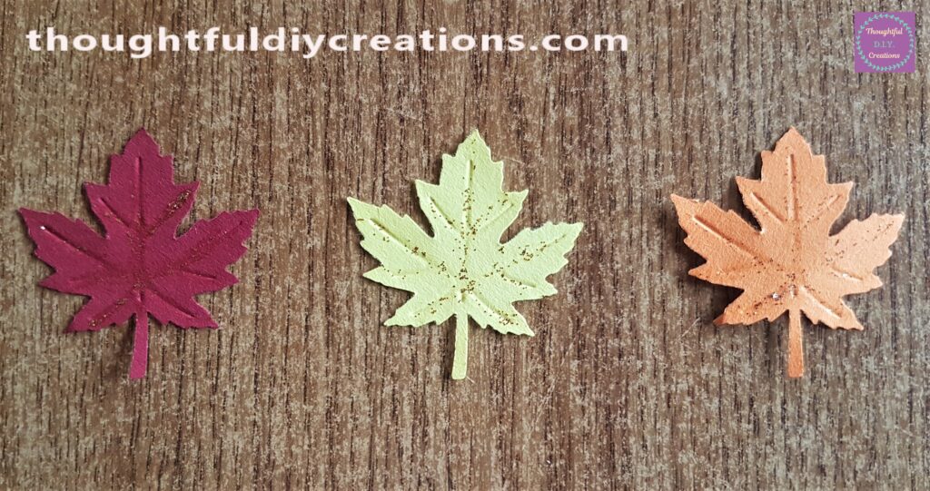 I made a Red, Yellow and Orange Leaf from the Punch and Coloured Cardstock. I added gold Glitter to each leaf.