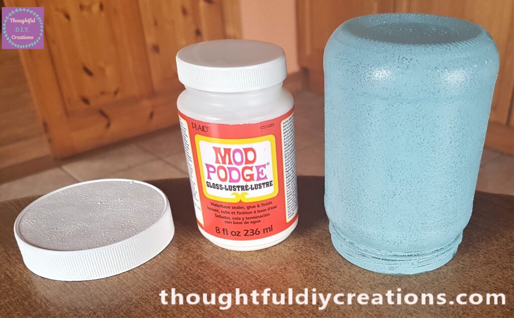 A layer of Mod Podge on the Top of the Lid and the Bottom and Sides of the Jar to Seal the Paint.