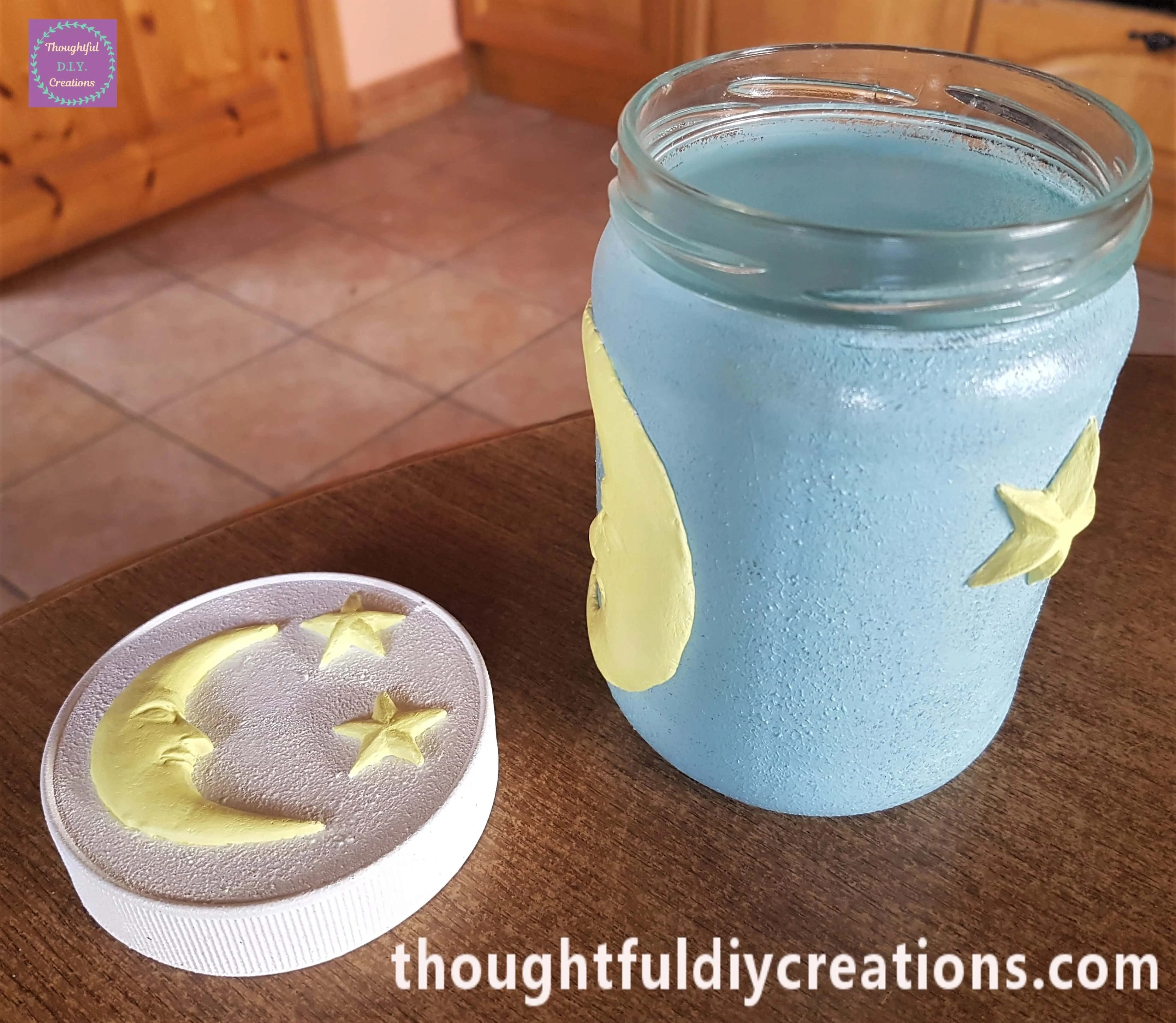 The lid and jar after the moon and stars were painted yellow.
