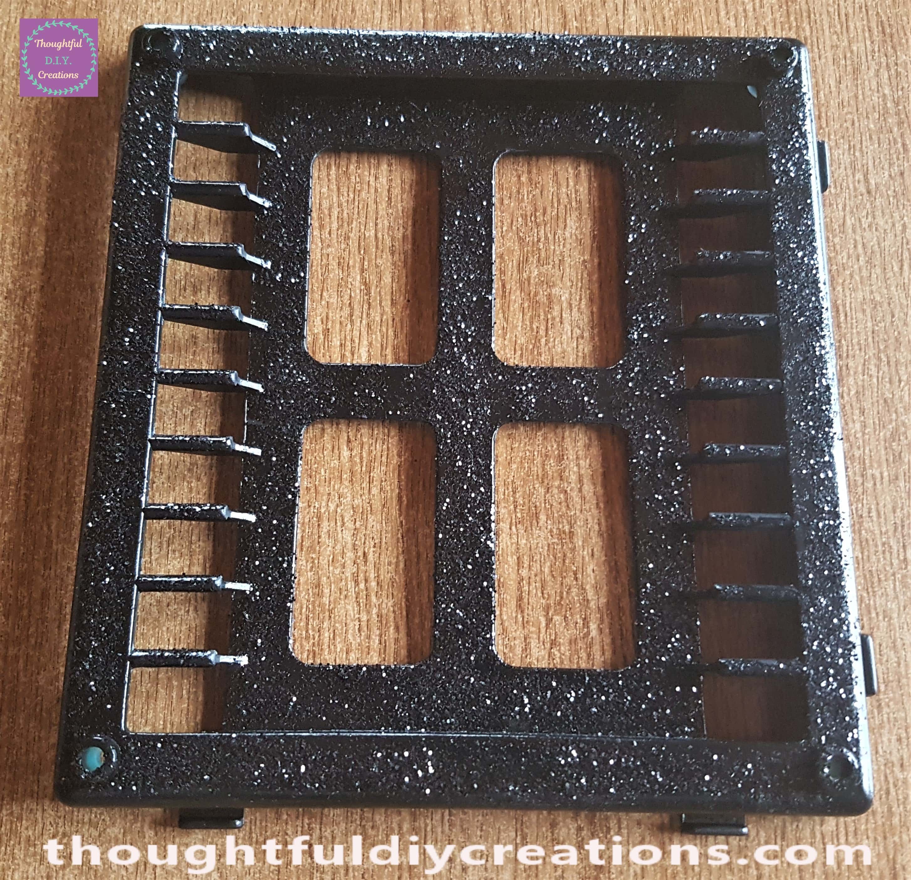 I spread Mod Podge Gloss all over the Halloween Window and then sprinkled black glitter over the glue.