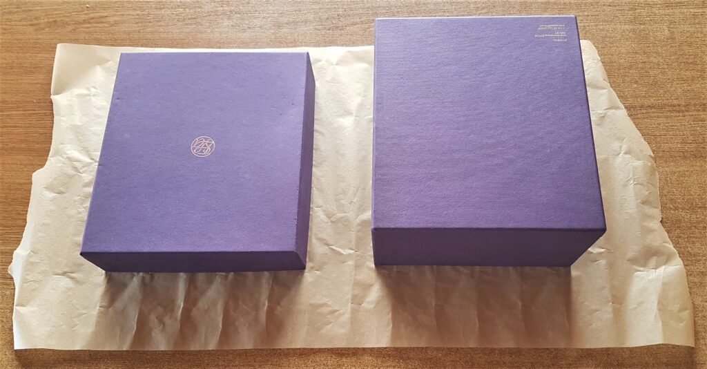 Baking Paper on the Table. Box and lid on the baking paper.