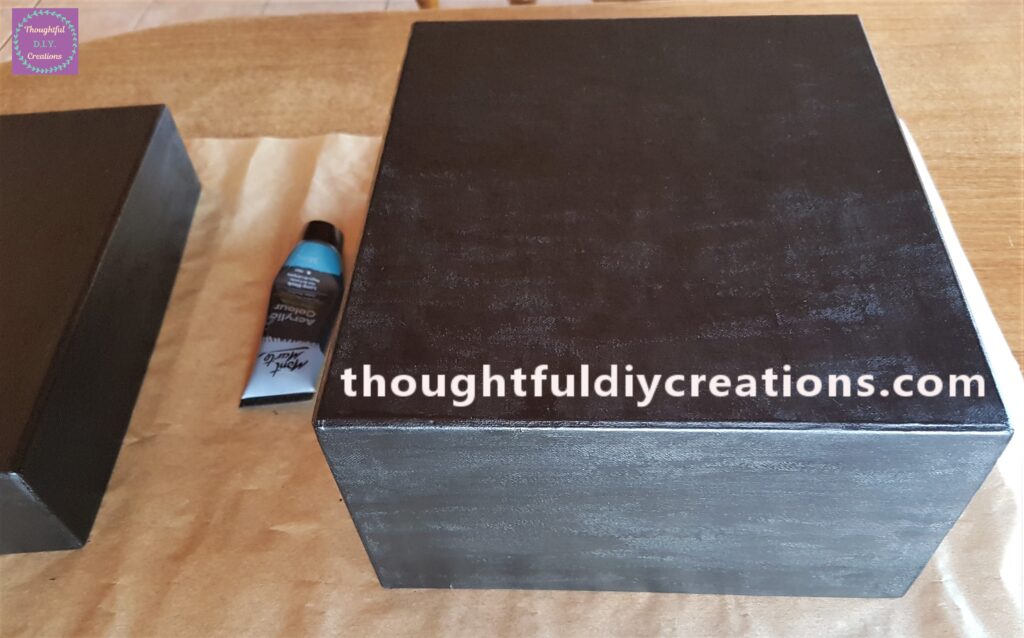 I applied a layer of black acrylic paint to the box with a flat paintbrush.
