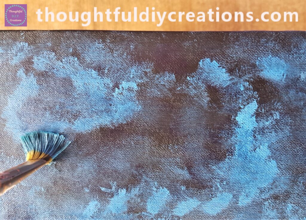 The paintbrush being pressed down onto the box. It is best to use an old paintbrush as the whole box and lid will be painted in this way.