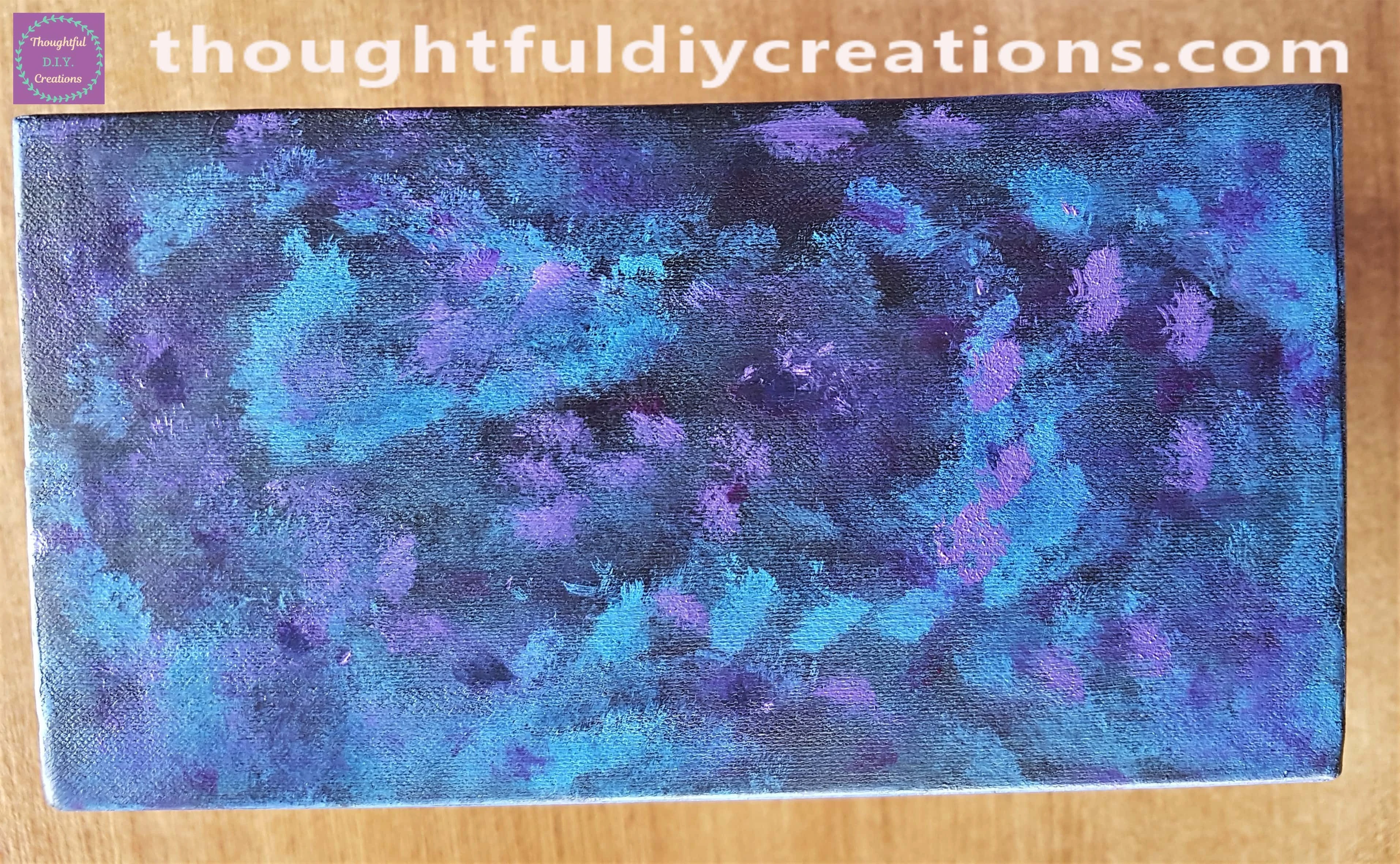 I put some of the light purple paint onto different parts of the box.