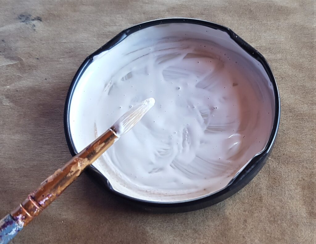 I added a couple drops of water and mixed it with the paint using a paintbrush.