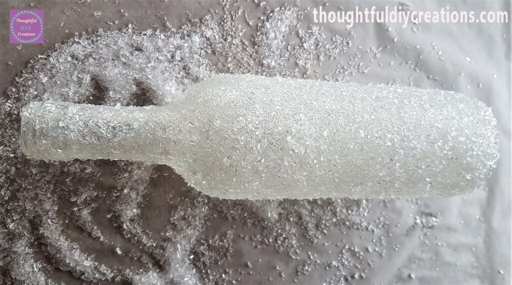 I picked up small handfulls of epsom salts and pressed them into the top part of the bottle, I continued until it had an even layer.