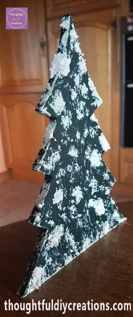 Snow paste on the tree with the palette knife, bigger lumps in different areas to look natural.