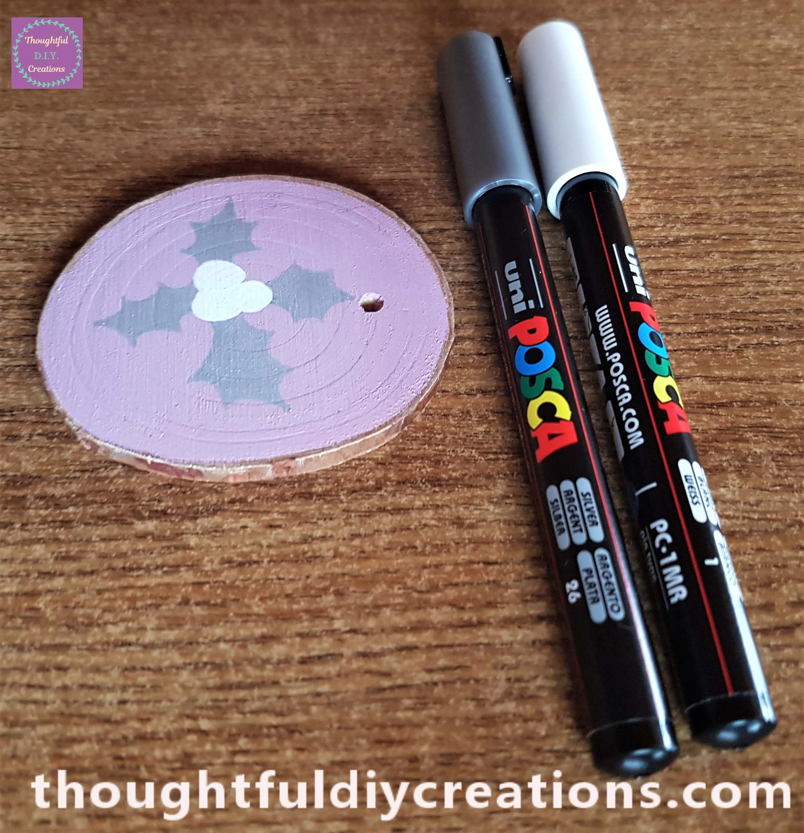 I drew and coloured Holly Leaves with a silver paint pen, berries with a white paint pen.