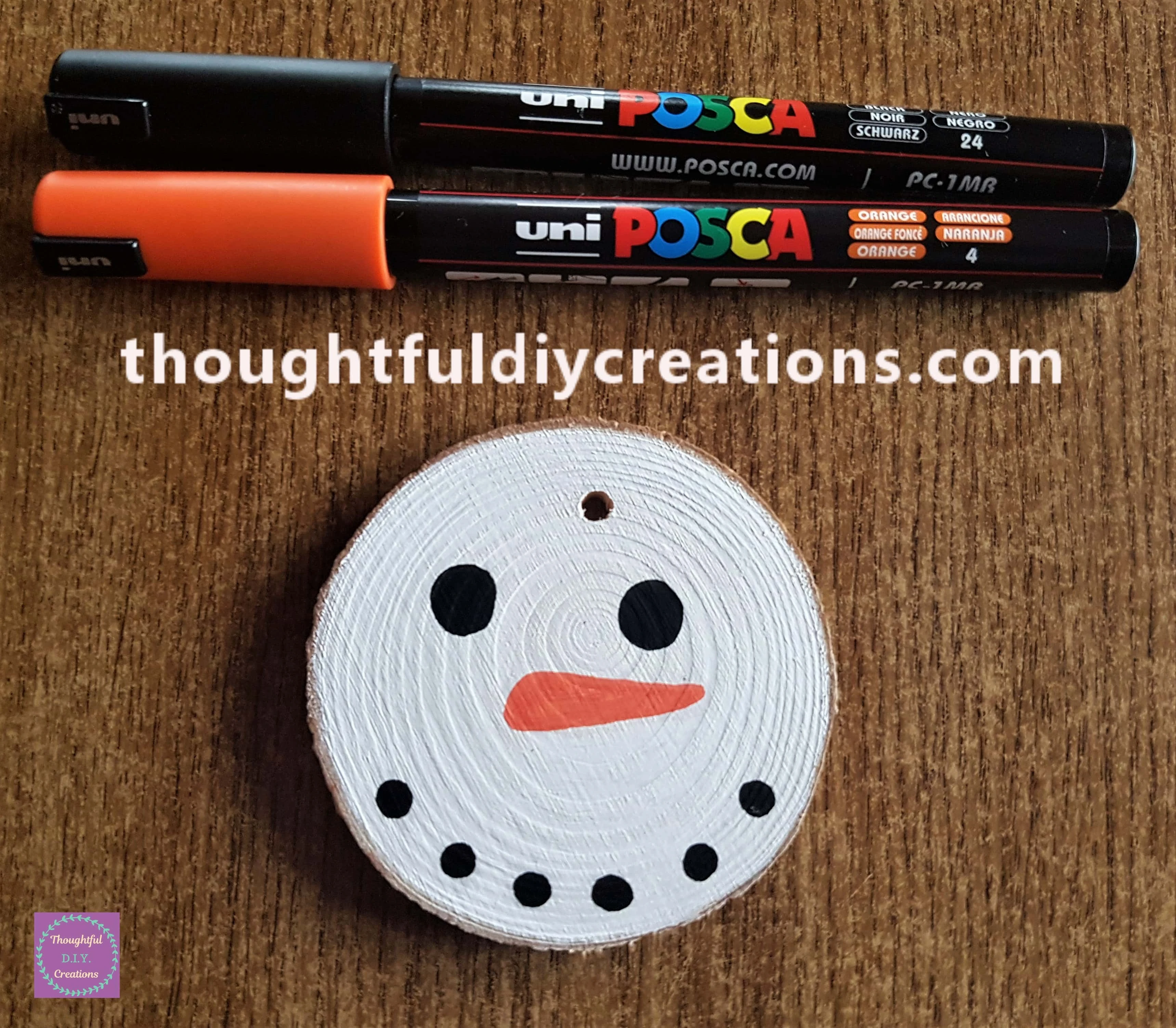 Snowman's Face, Black Paint pen for the eyes and mouth, orange for the nose.