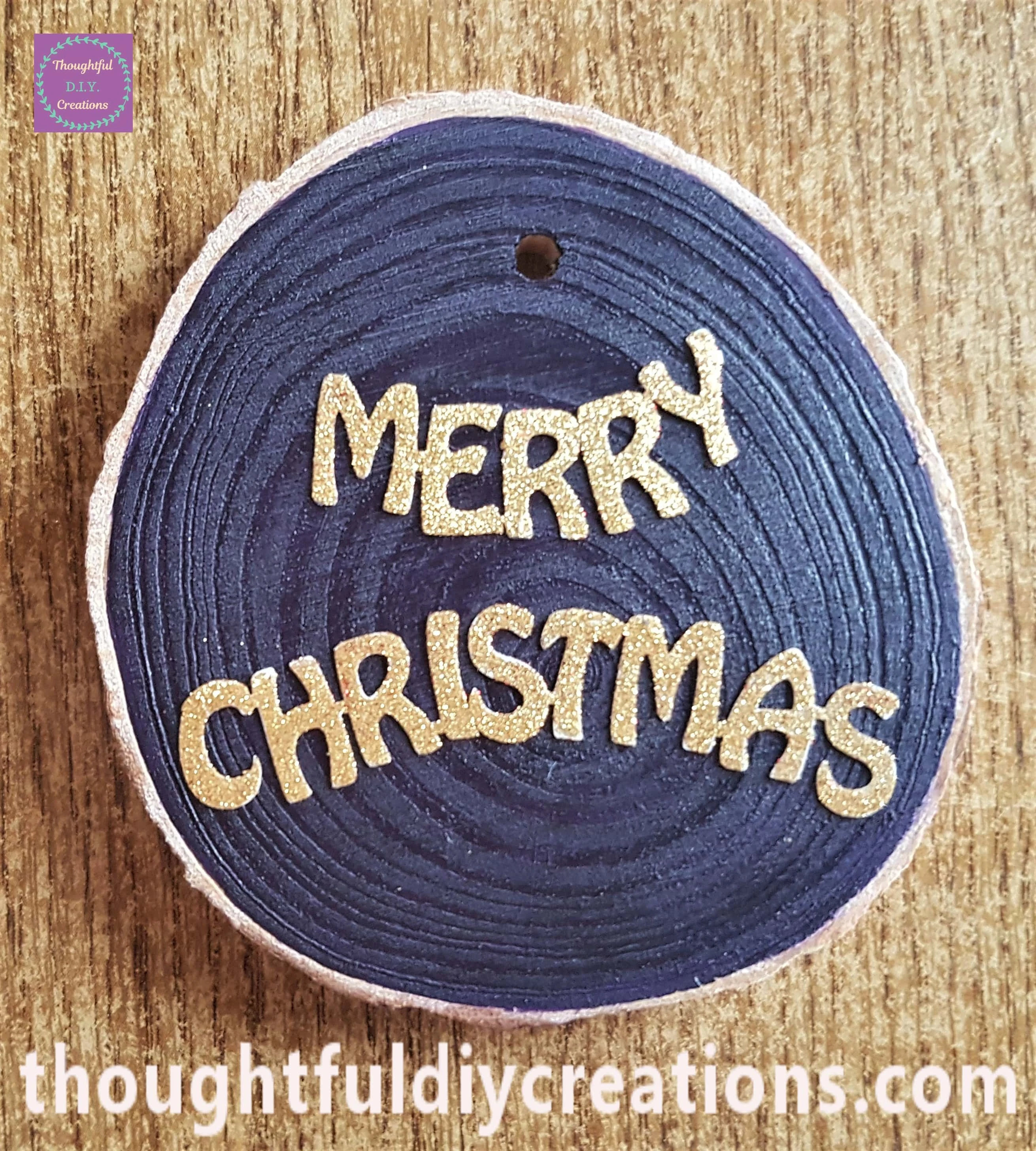Gold Merry Christmas Sticker attached to the purple wood slice.