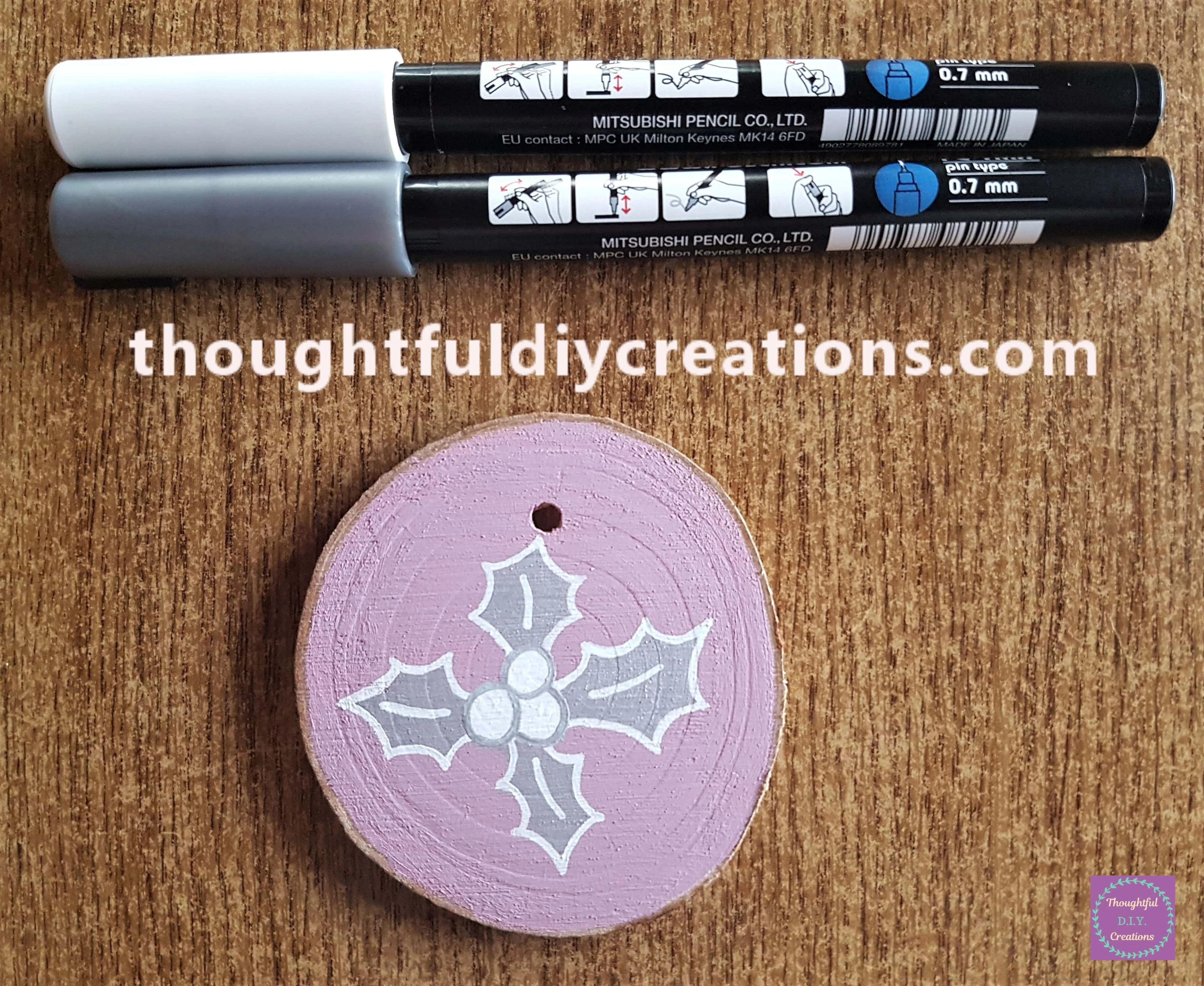 I outlined the leaves with the white paint pen and outlined the berries with the silver paint pen.