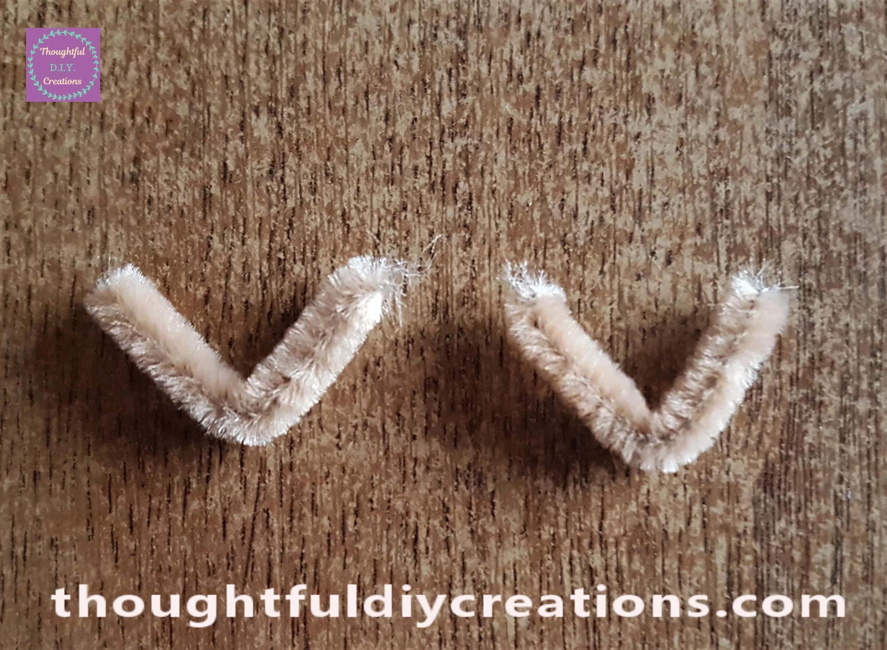 I got the smallest pipe cleaners and twisted them into a V shape.