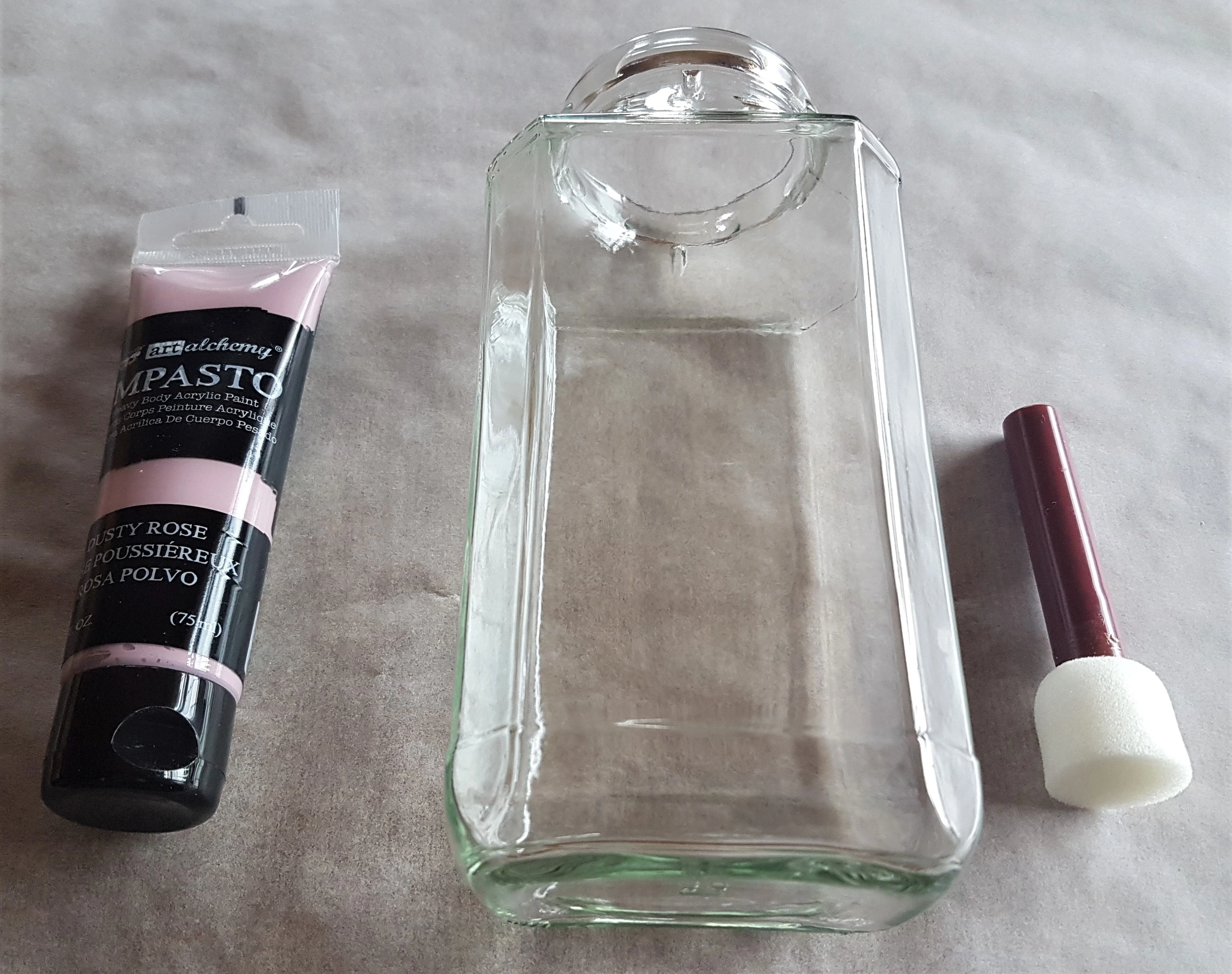 Sheet of Baking Paper on the Table. Dusty Rose Acrylic Paint, bigger Sponge with Handle, Jar ready to Paint.