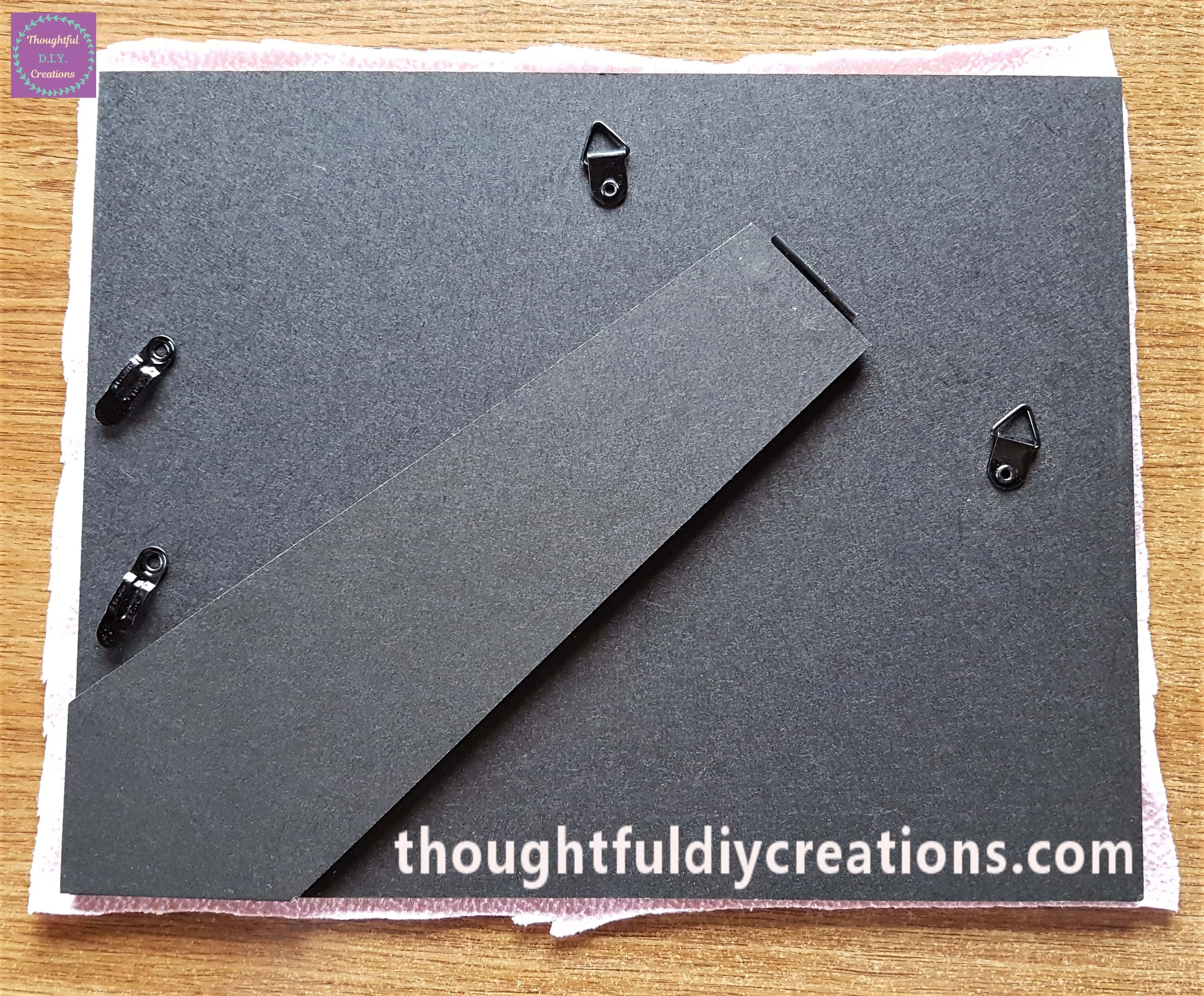 I turned the backing board over and cut the fabric around the frame.