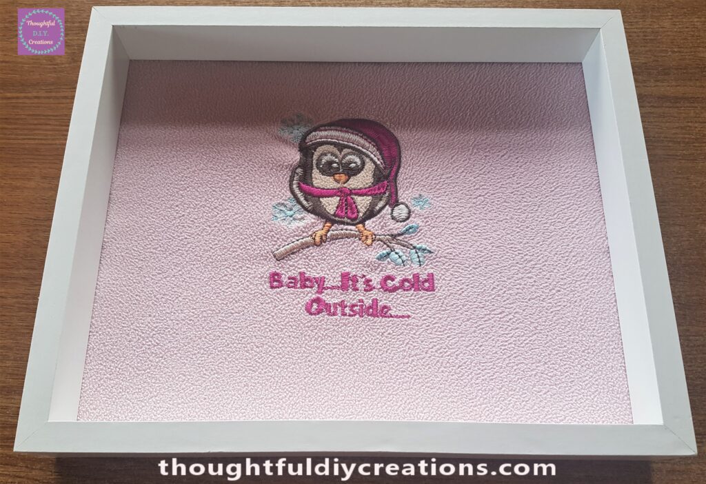 I cut the excess fabric around the edges and put the backing board back into the frame.