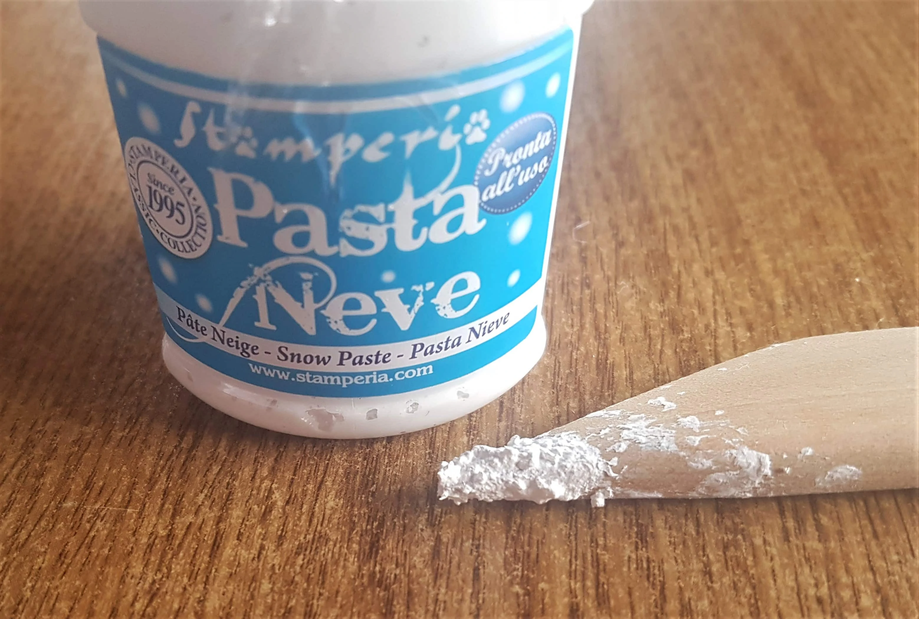 Tub of Snow Paste and Wooden Spatula.