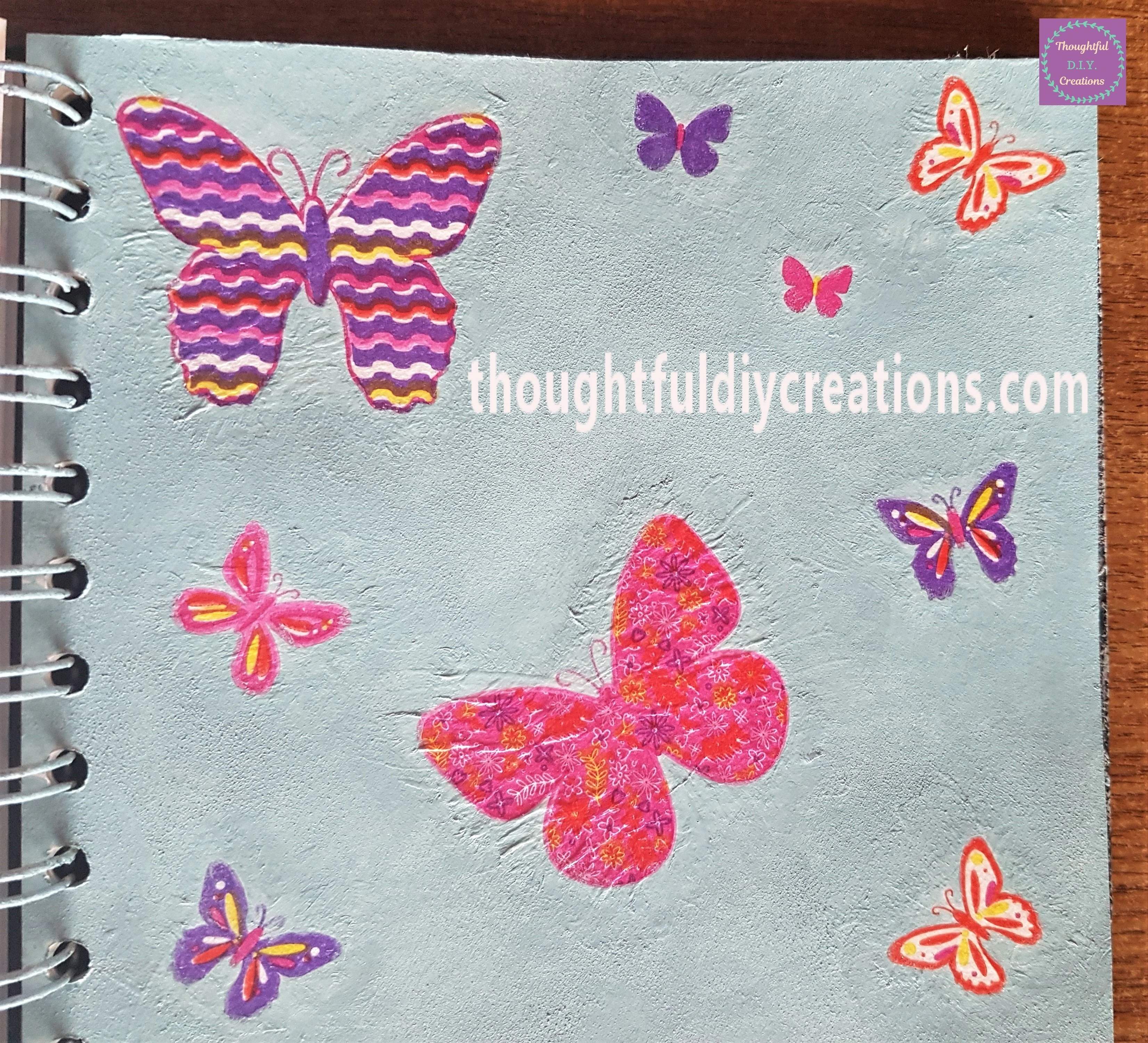 I Painted all around the edges of the butterflies with the paintbrush and blue paint to blend each Napkin into the page.