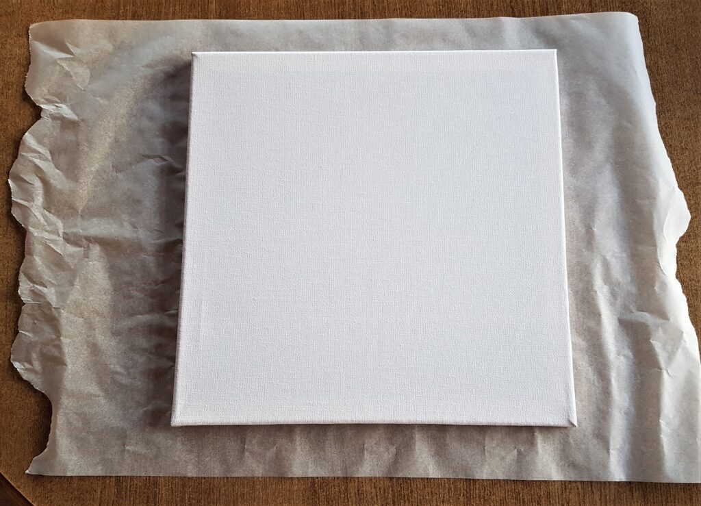 Baking Parchment Paper on the Table to protect it while Painting the Canvas.