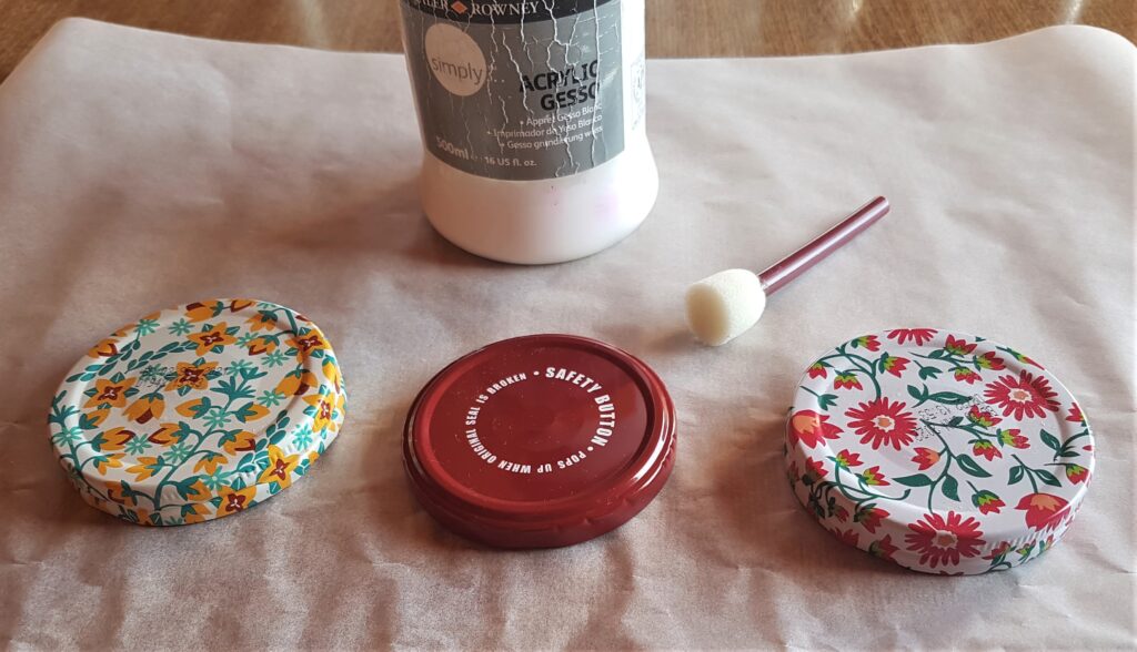 3 Lids on the Baking Paper and my Acrylic White Gesso and a small flat Sponge with handle.