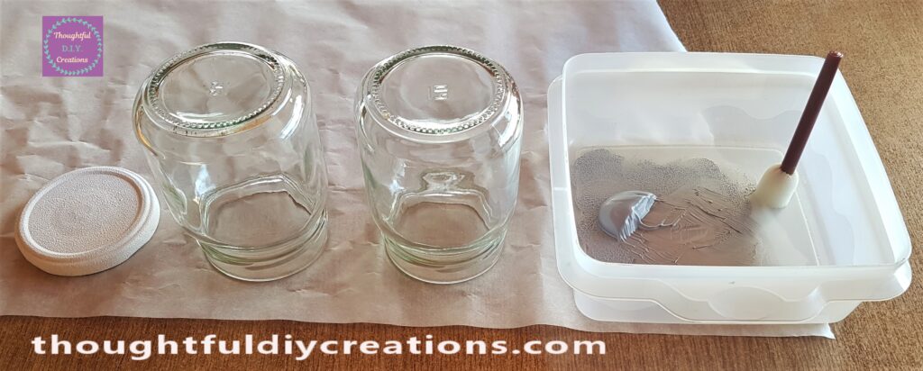 I poured some Silver Paint into a Tub. I put the Jars upside down on the Baking Paper.