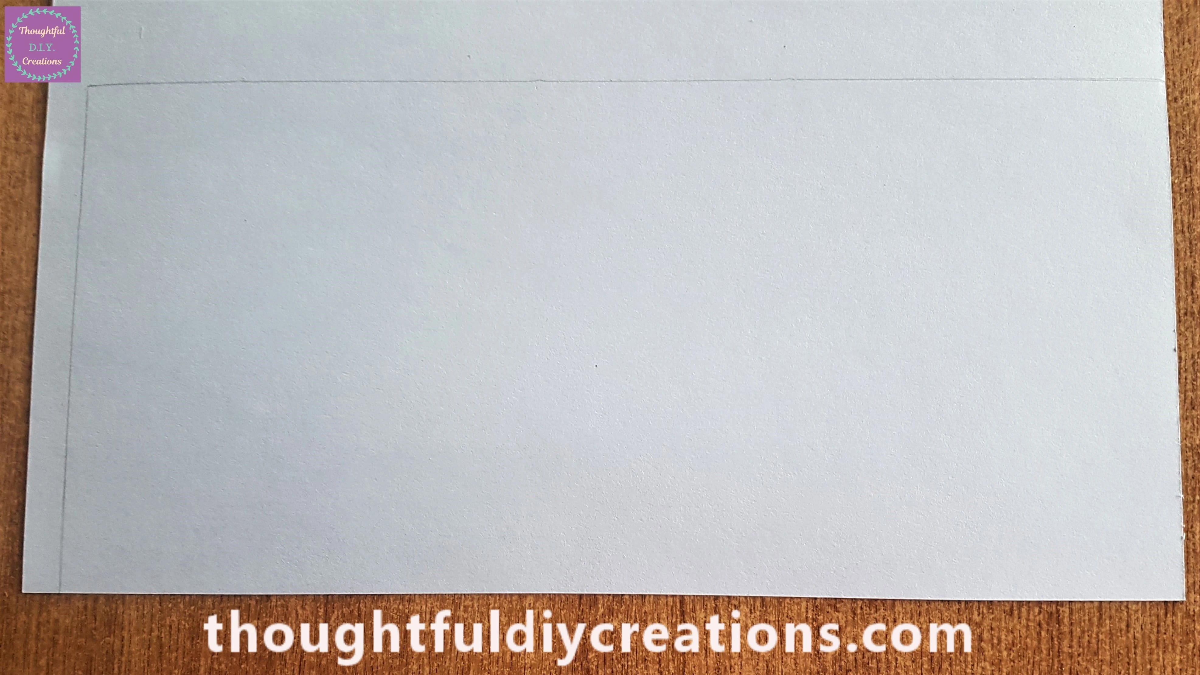 The outline of the pencil on the blue sheet.