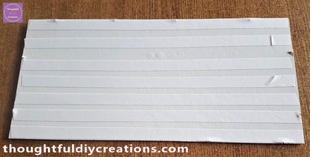 I cut strips of Double-Sided Tape and attached them to the front of the backing of the frame.