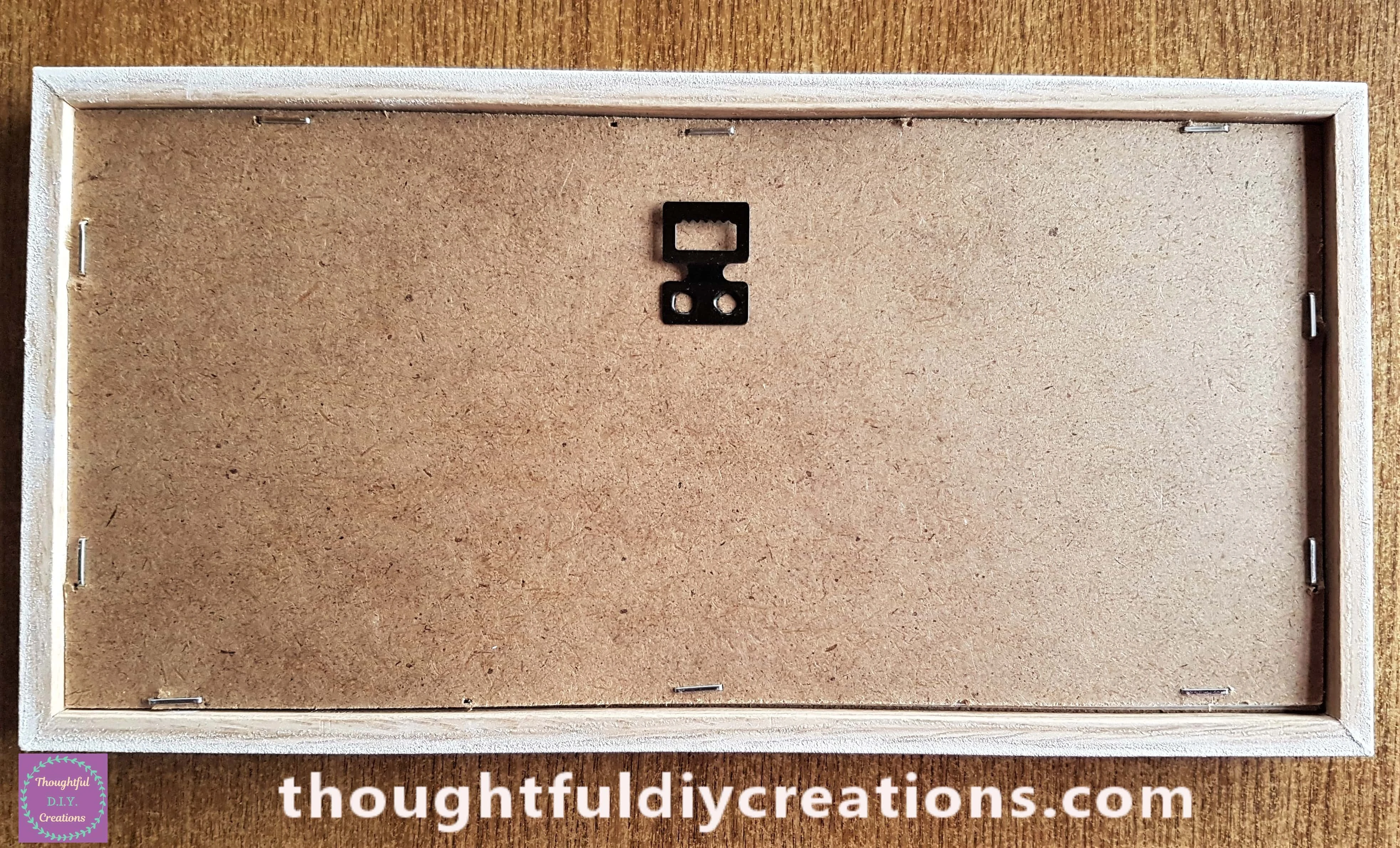 I stapled the backing of the frame back into the frame. I added 10 staples altogether.