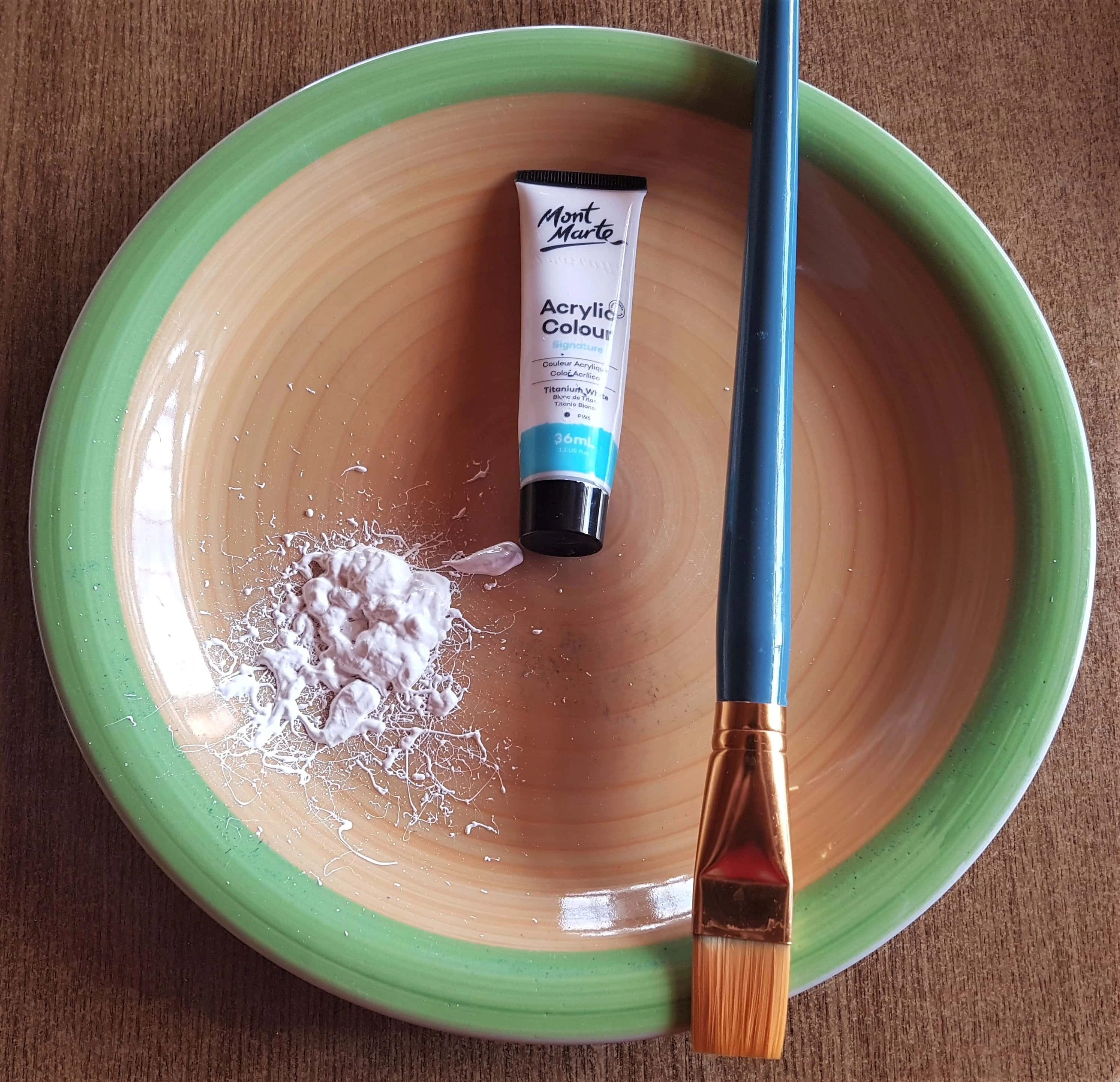 Titanium White Acrylic Paint on an old Plate. I got my Flat 1 inch Paintbrush.