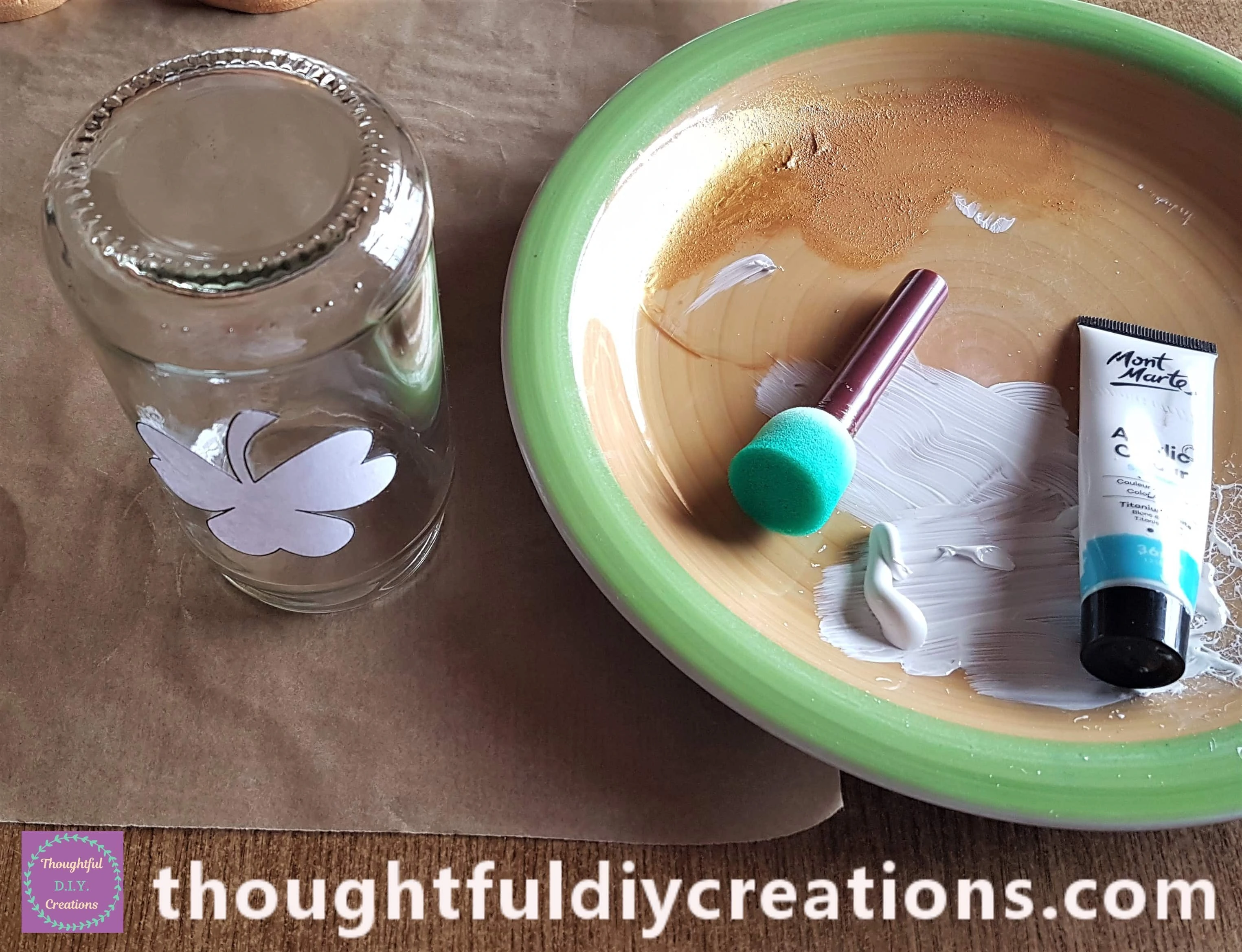 I turned the Jar upside down onto the Baking Sheet. I poured White Acrylic Paint onto a Plate, I got a Sponge.