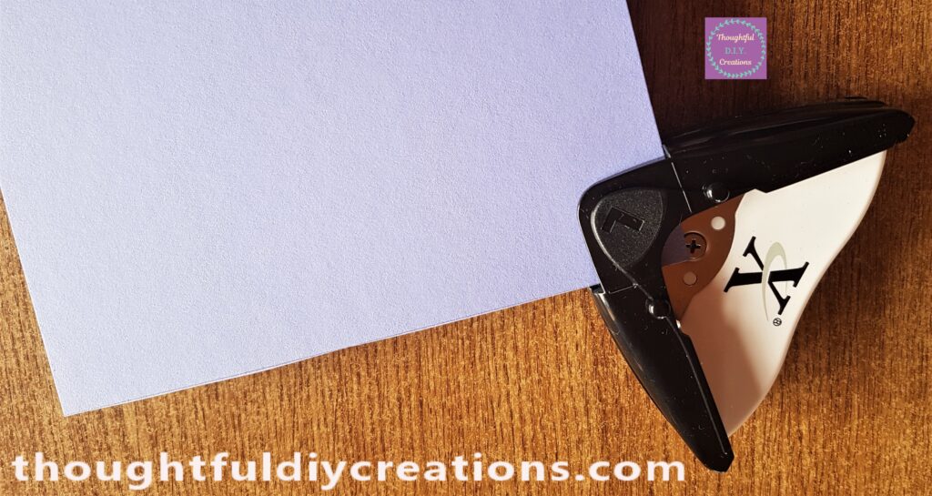 I put the Purple Card into the Outer Part of the Corner Punch and pressed down on the Punch to remove the Corner of the Card.