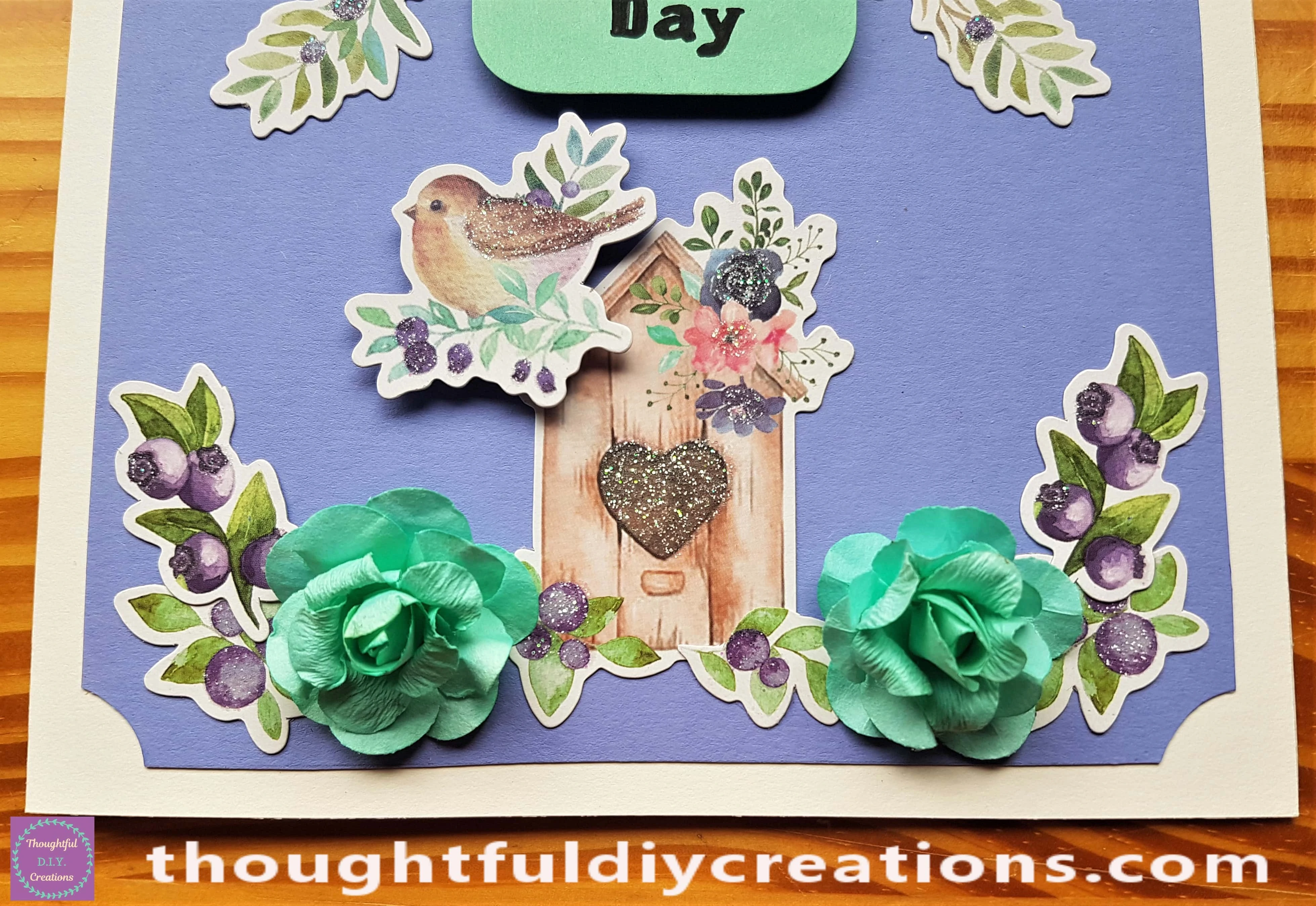 I put Hot Glue on the back of 2 Green Flowers and attached them to the Card.