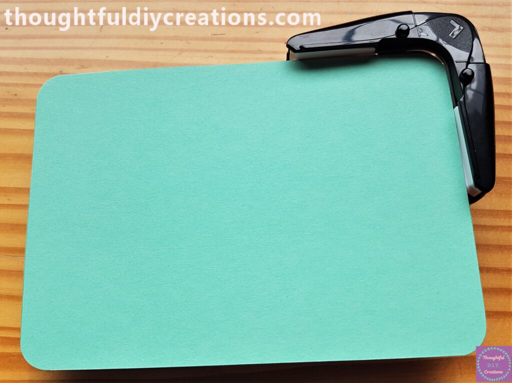 I put each Corner of the Green Card into the Inner Part of the Corner Punch and Rounded each Corner.