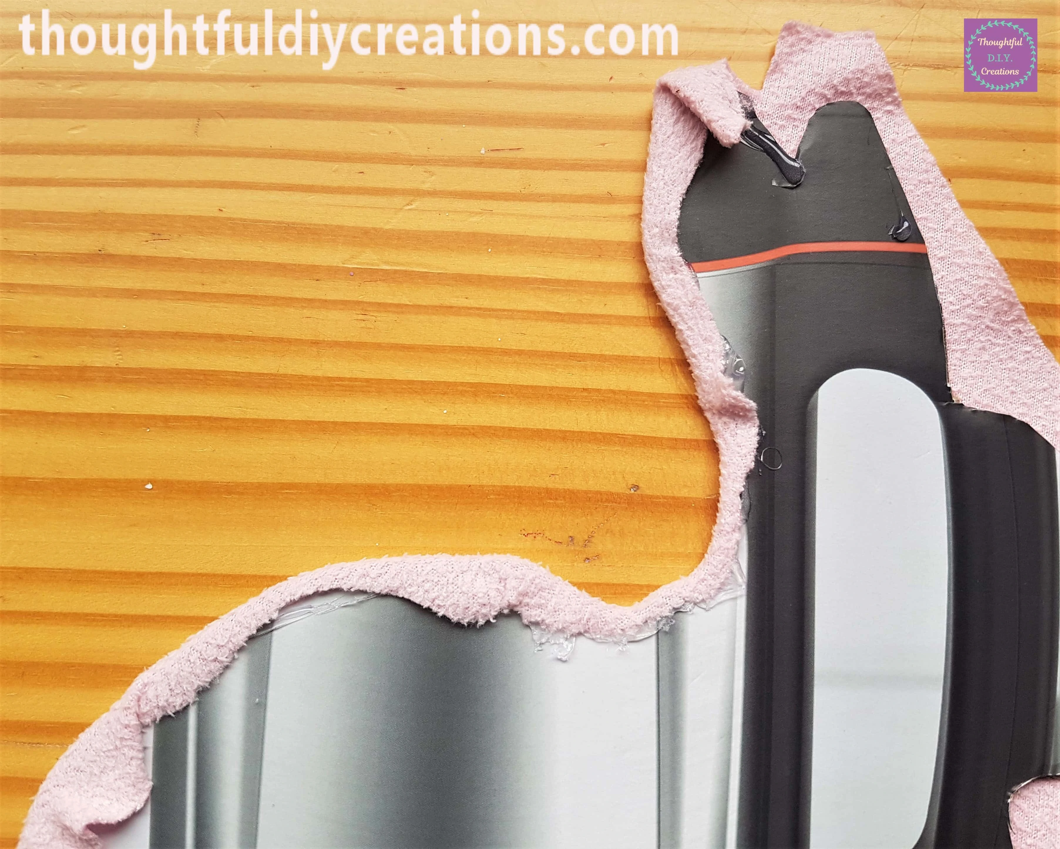 I added more Hot Glue to the next section of Cardboard and attached the material to it.