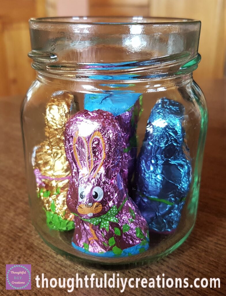 4 of the Easter Bunnies standing up-right around the Jar and One upside down in the center to fill it.