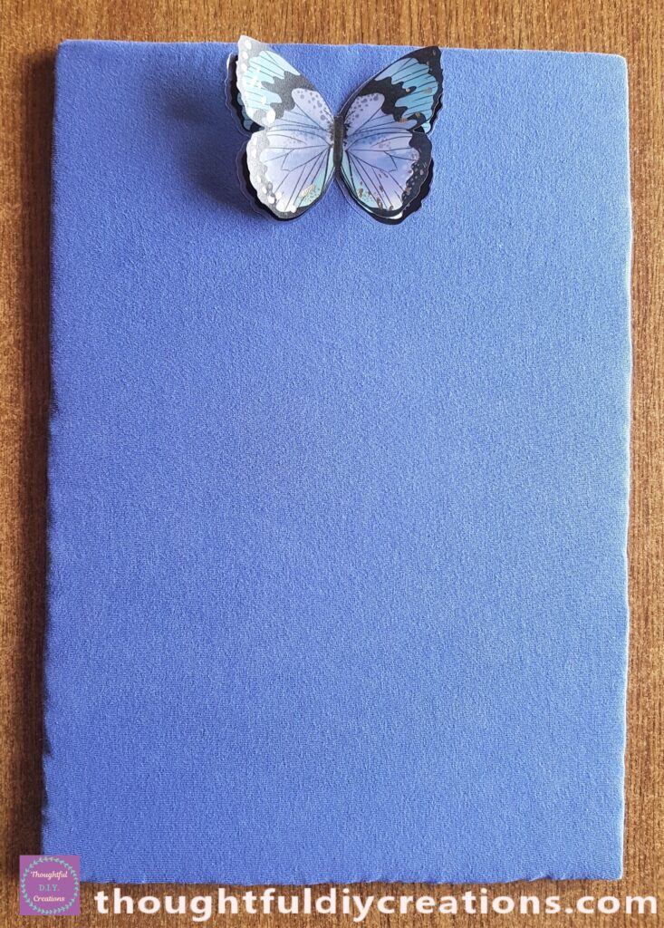 I attached the Blue and Black Butterfly Sticker to the top mid-section of the memo board.