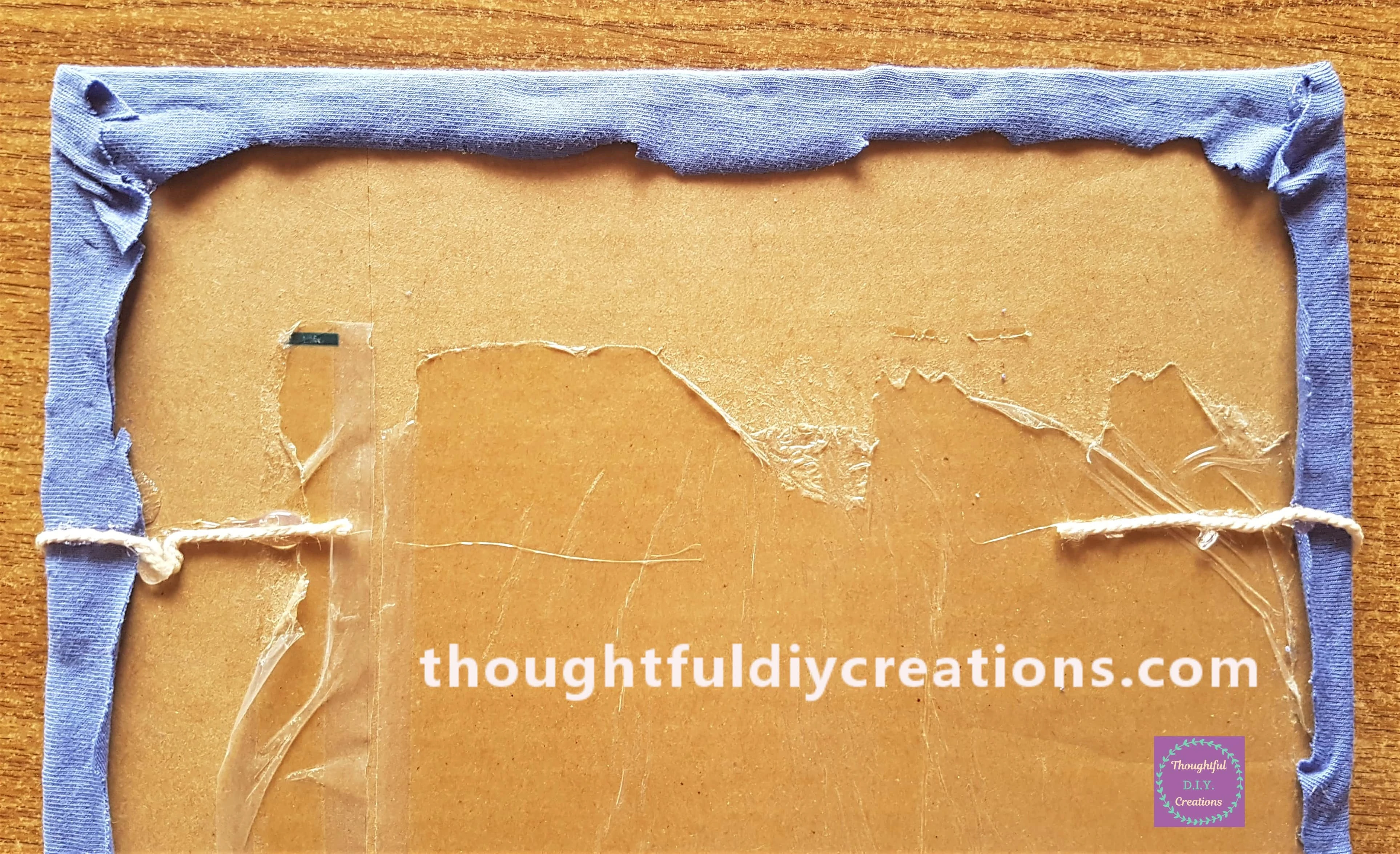 I attached the first string to the back of the memo board using hot glue.