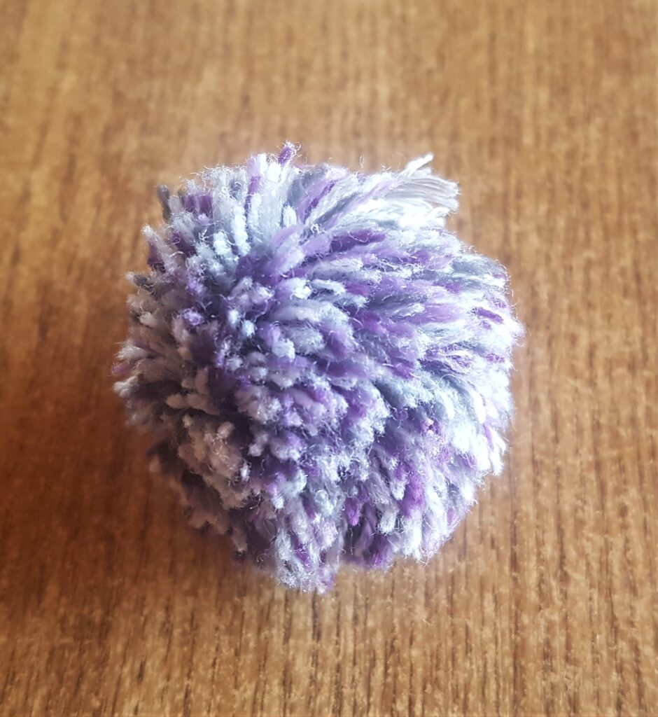 I got a Purple and Grey Pom Pom from my Supplies.
