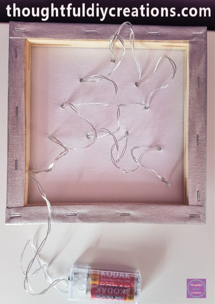 I poked each Light through each Hole on the Canvas.