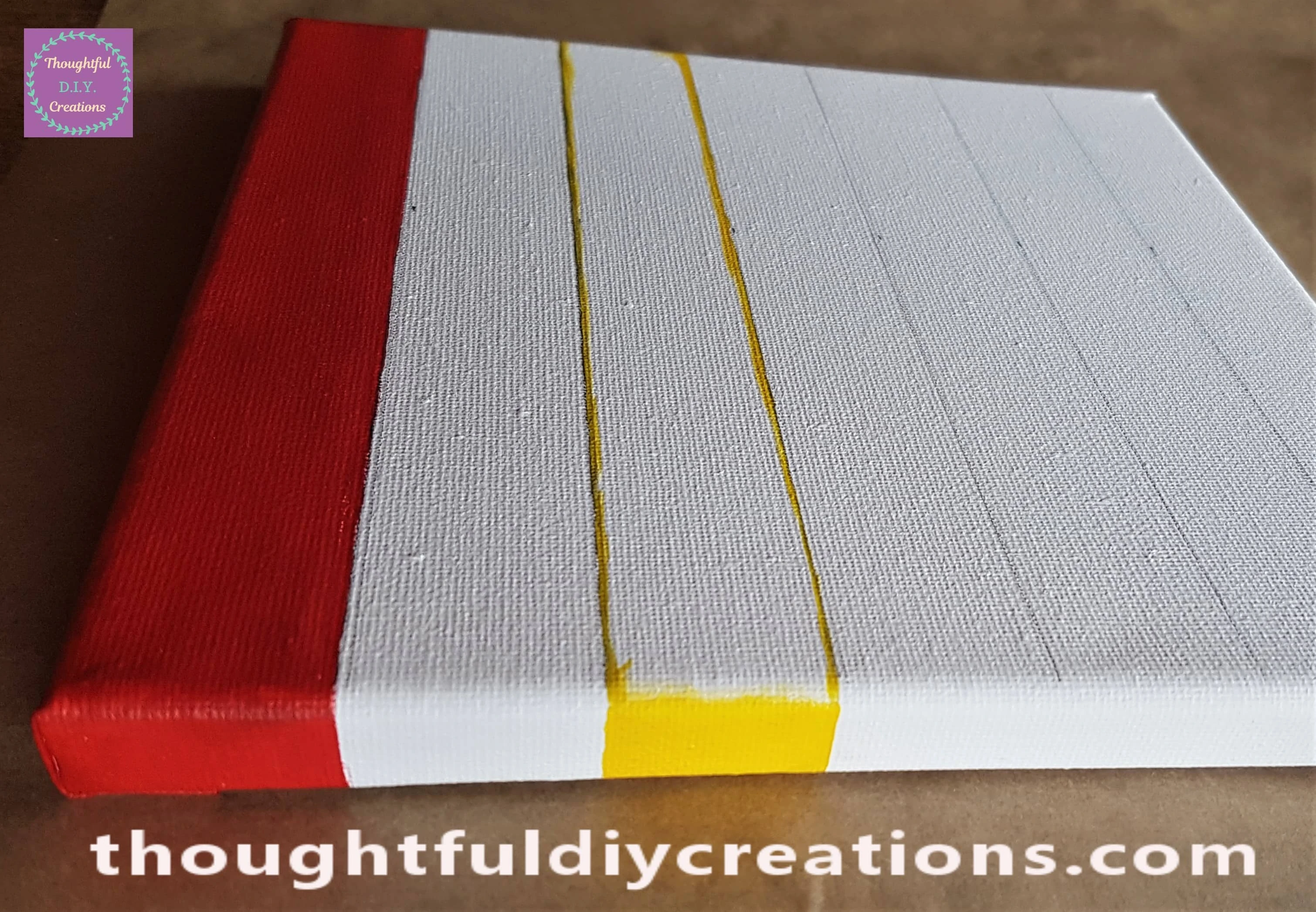 I painted over the 2 pencil lines on the Canvas with the Paintbrush and yellow paint.