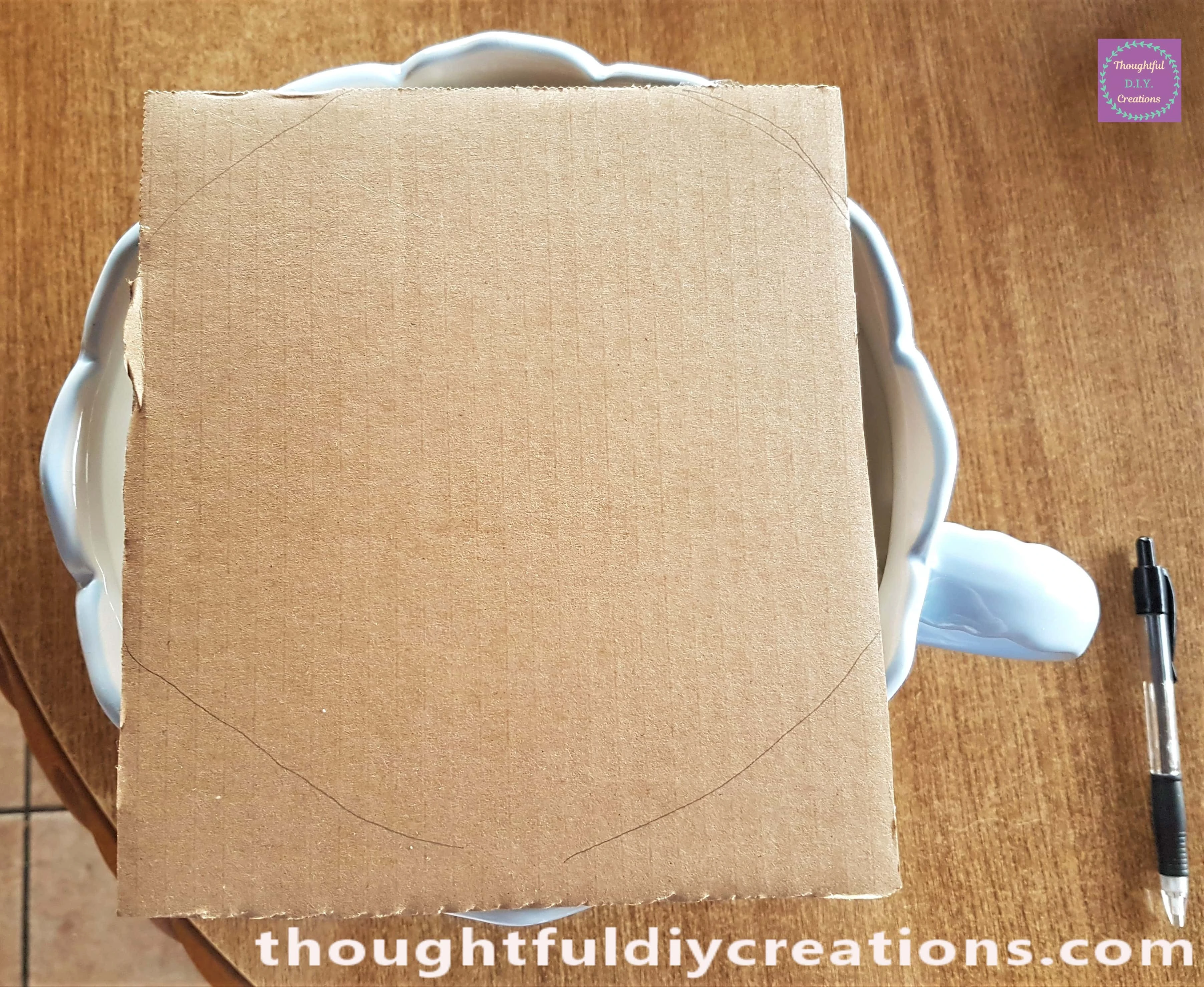 I got a piece of cardboard and roughly drew around the inside of the Teacup with a Pencil.