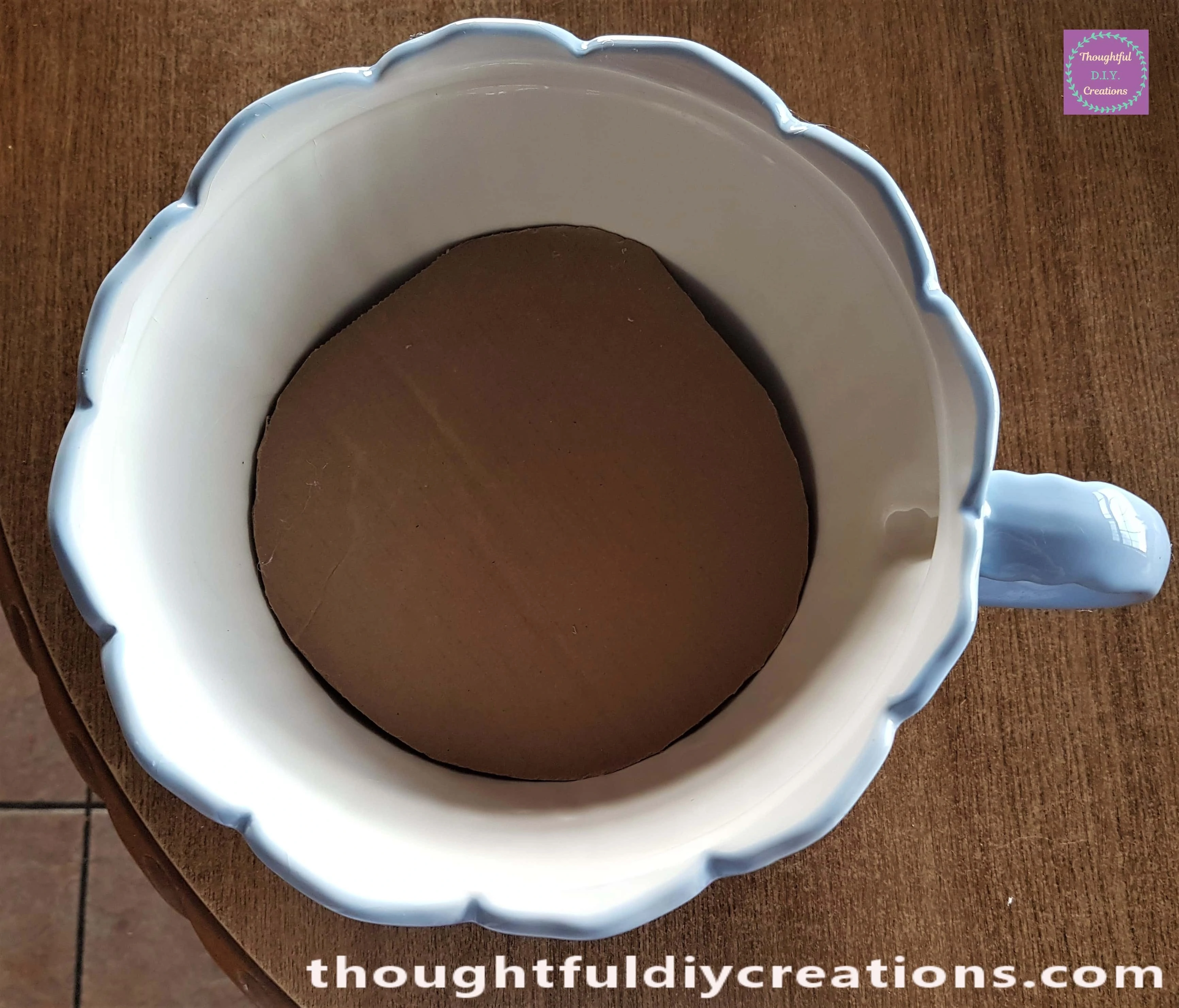 I put Hot Glue on the bottom of the Cardboard and held it to the Foam.This provided a Flat base for the Fairy Garden.