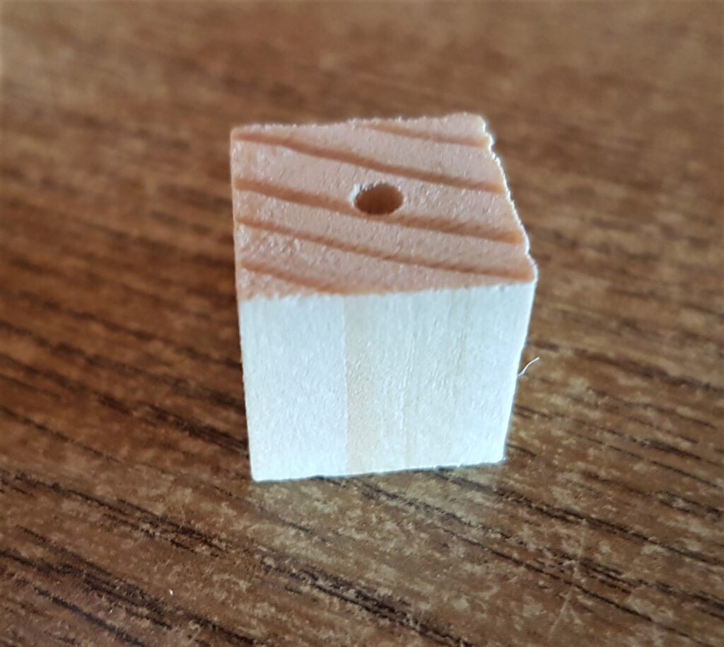 I got a small Cube shape with a hole in one side from the Wooden Craft Pack for the Chimney.