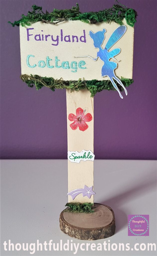 I Hot Glued the lollipop Stick to the Wood Slice and added Moss to cover the Glue.