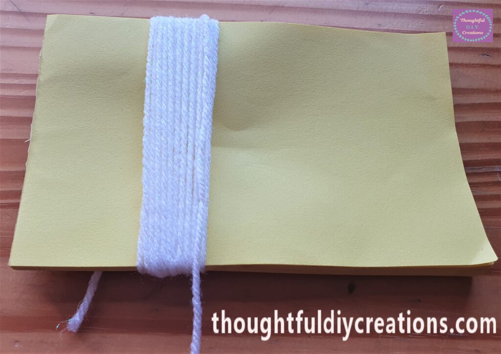 I continued to wrap the wool tightly around the Notepad.
