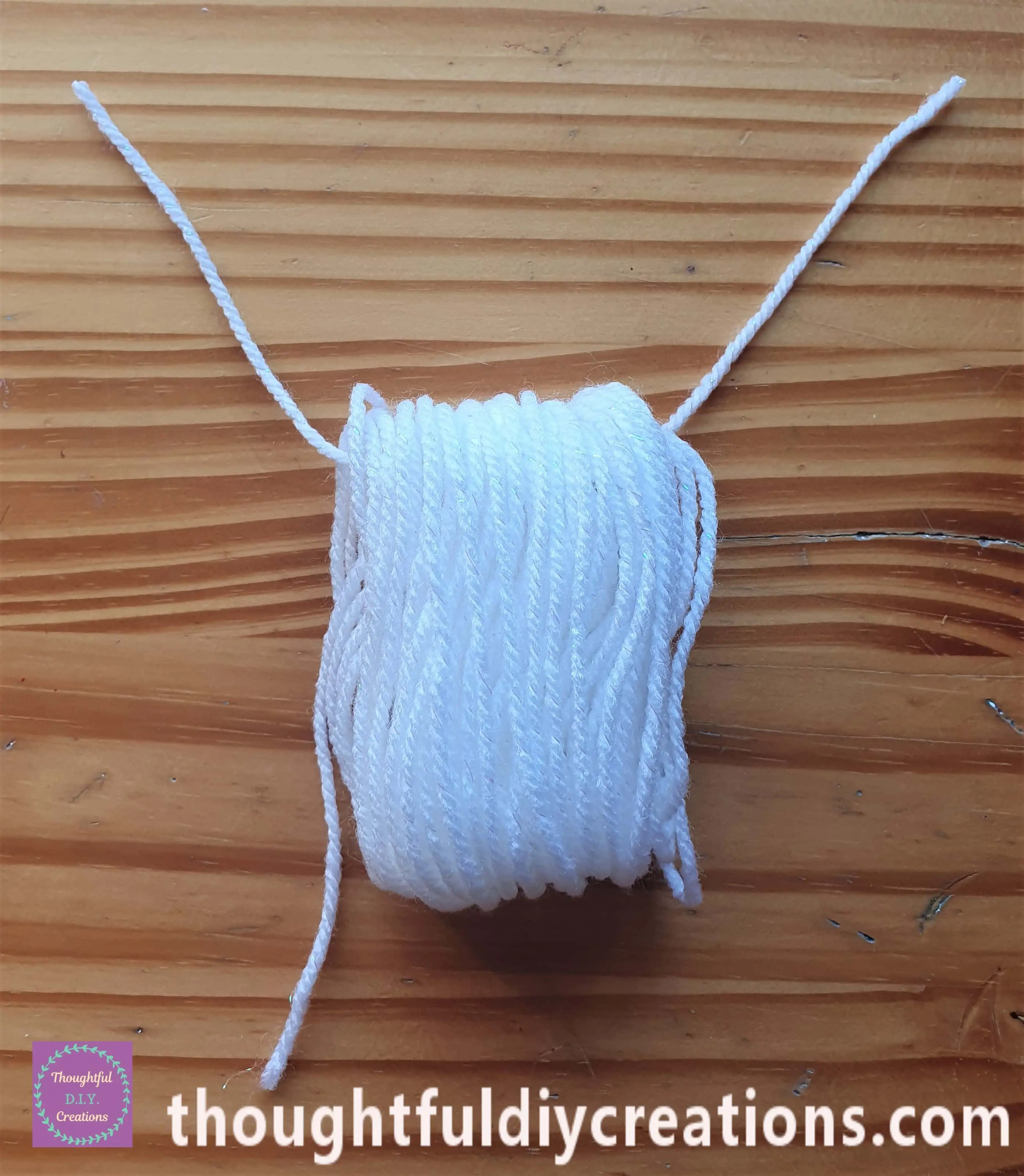 I placed the String in between the gap at the top of the Bundle of Wool.