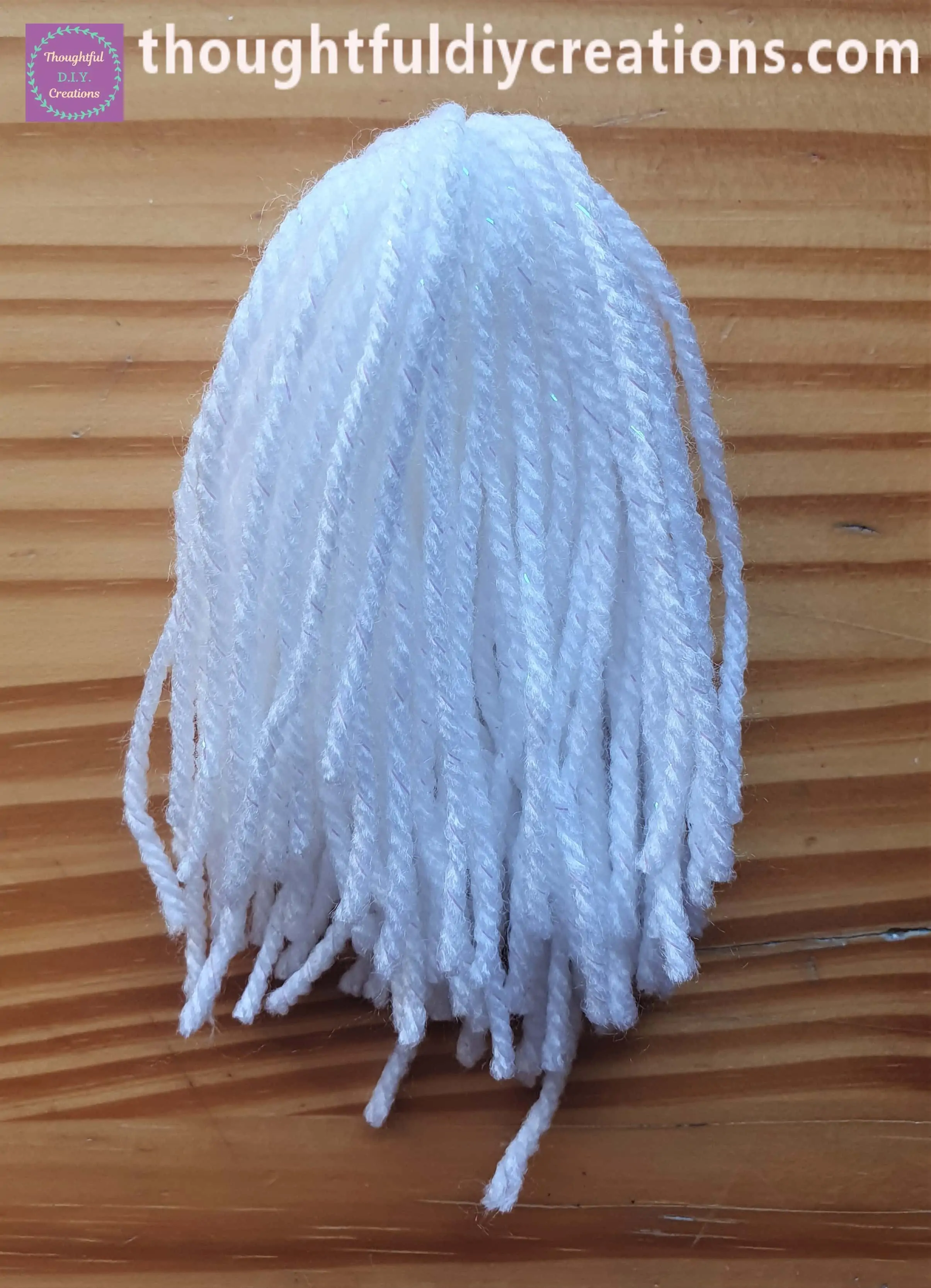 I folded one bundle of wool over the other with the double-knot underneath.